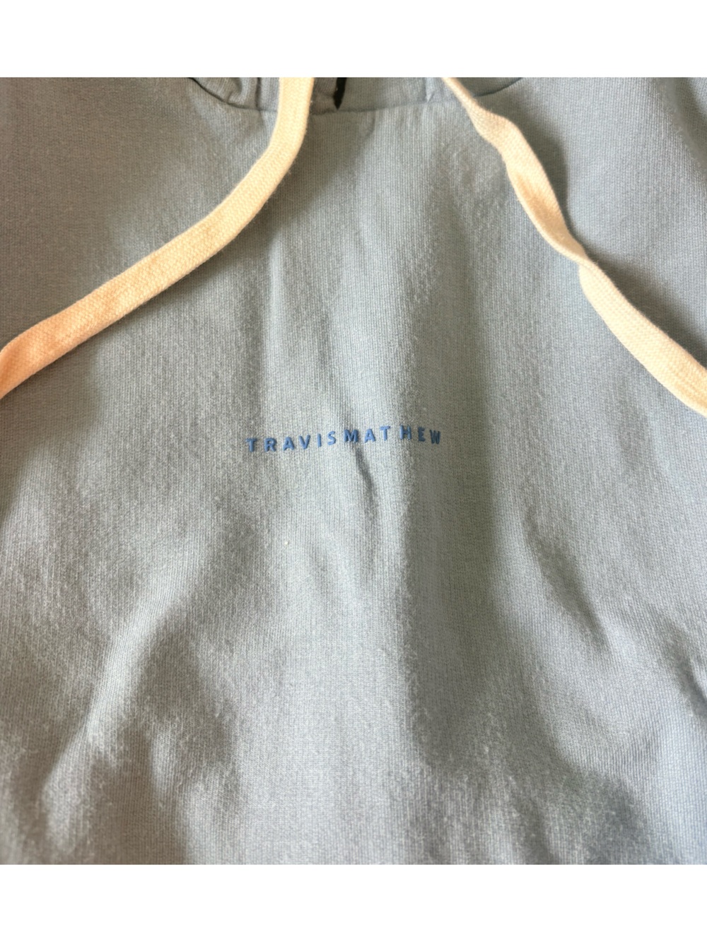 TravisMathew Light Blue Hoodie with Black Brand Tag
